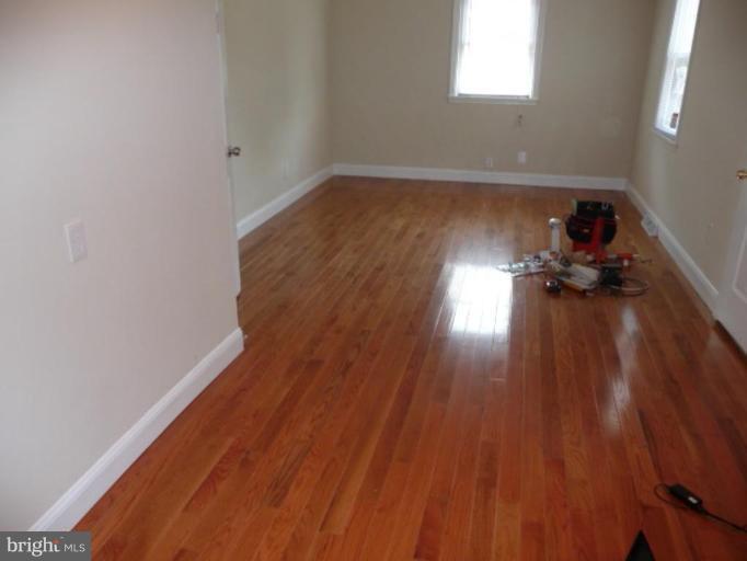 4502 Morgan Road Suitland, MD 20746 - Photo 9 of 14 a view of empty room with wooden floor and fan