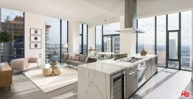 a large white kitchen with a large window and sink
