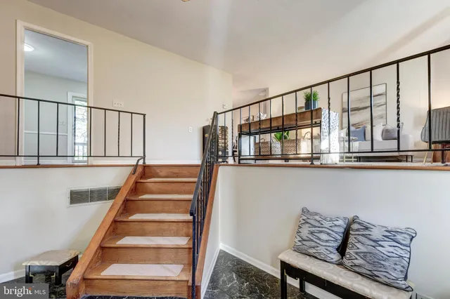a view of a dining room with furniture a chandelier and wooden floor