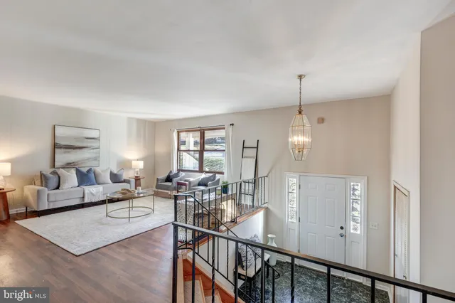 a kitchen with stainless steel appliances granite countertop a stove top oven a sink dishwasher and cabinets with wooden floor