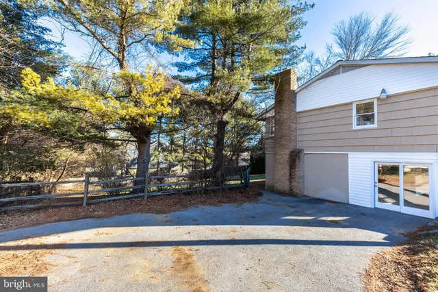 a view of a hallway with wooden floor and a potted plant