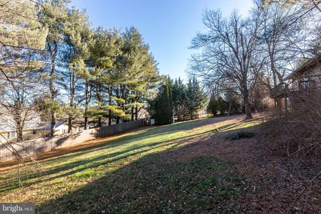 a living room with furniture wooden floor and a chandelier