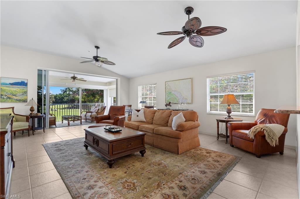 8500 Mystic Greens Way, Unit 506 Naples, FL 34113 - Photo 12 of 48 a living room with furniture and a large window