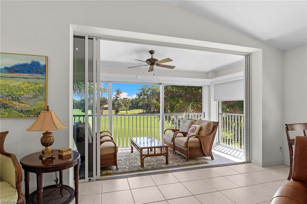 8500 Mystic Greens Way, Unit 506 Naples, FL 34113 - Photo 15 of 48 a living room with furniture and a floor to ceiling window