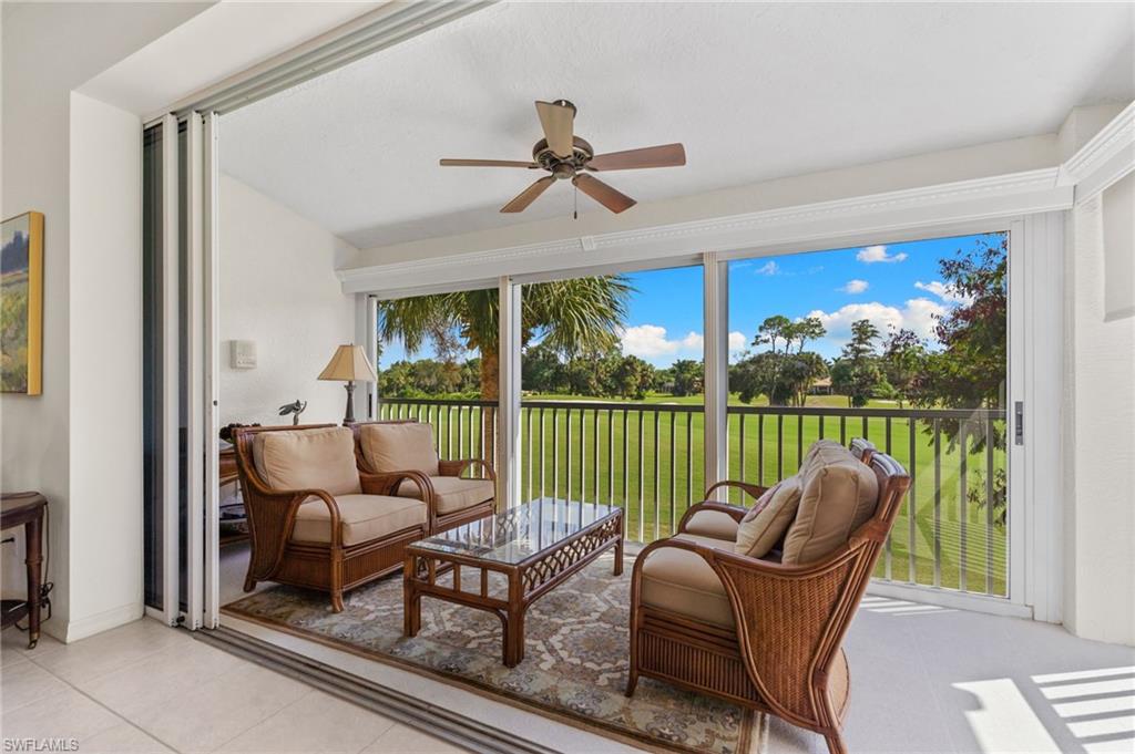 8500 Mystic Greens Way, Unit 506 Naples, FL 34113 - Photo 16 of 48 a living room with furniture and a floor to ceiling window