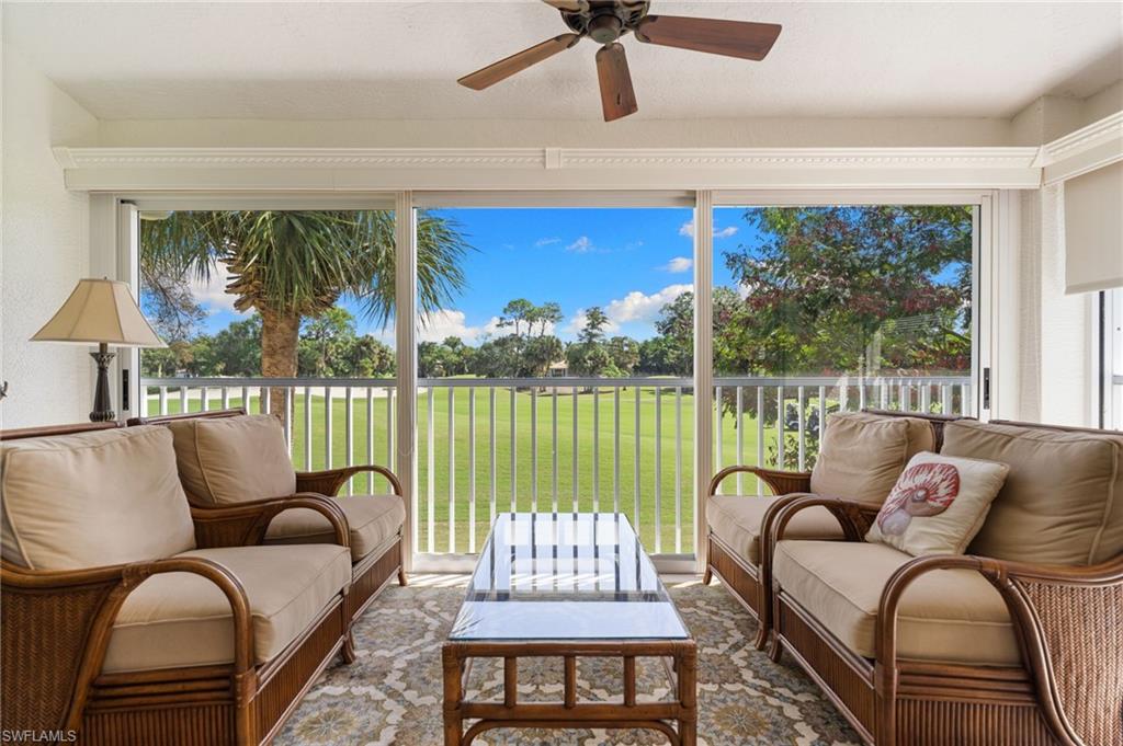 8500 Mystic Greens Way, Unit 506 Naples, FL 34113 - Photo 17 of 48 a living room with furniture and a large window