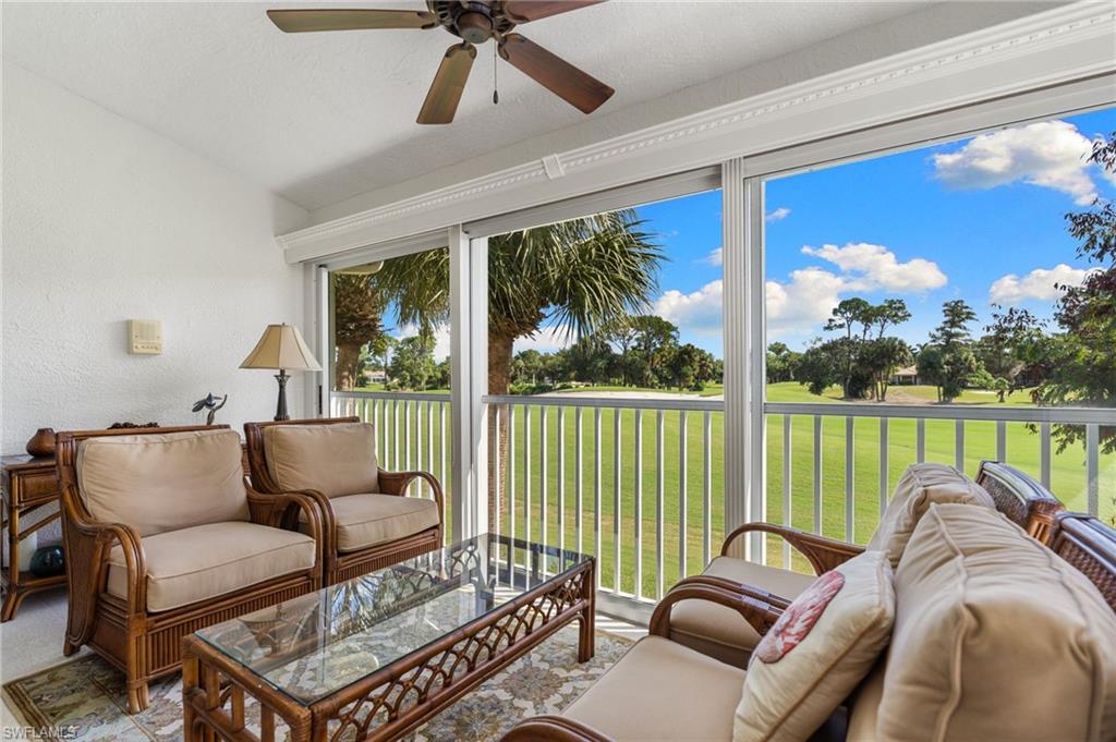 8500 Mystic Greens Way, Unit 506 Naples, FL 34113 - Photo 18 of 48 a living room with furniture and a large window