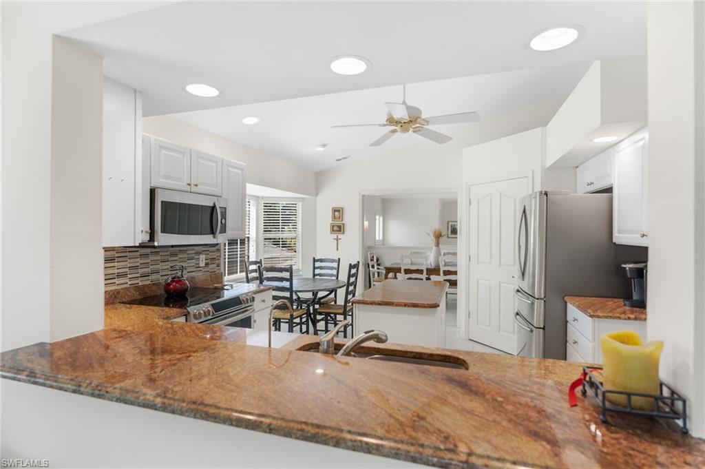 8500 Mystic Greens Way, Unit 506 Naples, FL 34113 - Photo 20 of 48 a view of a living room and dining room