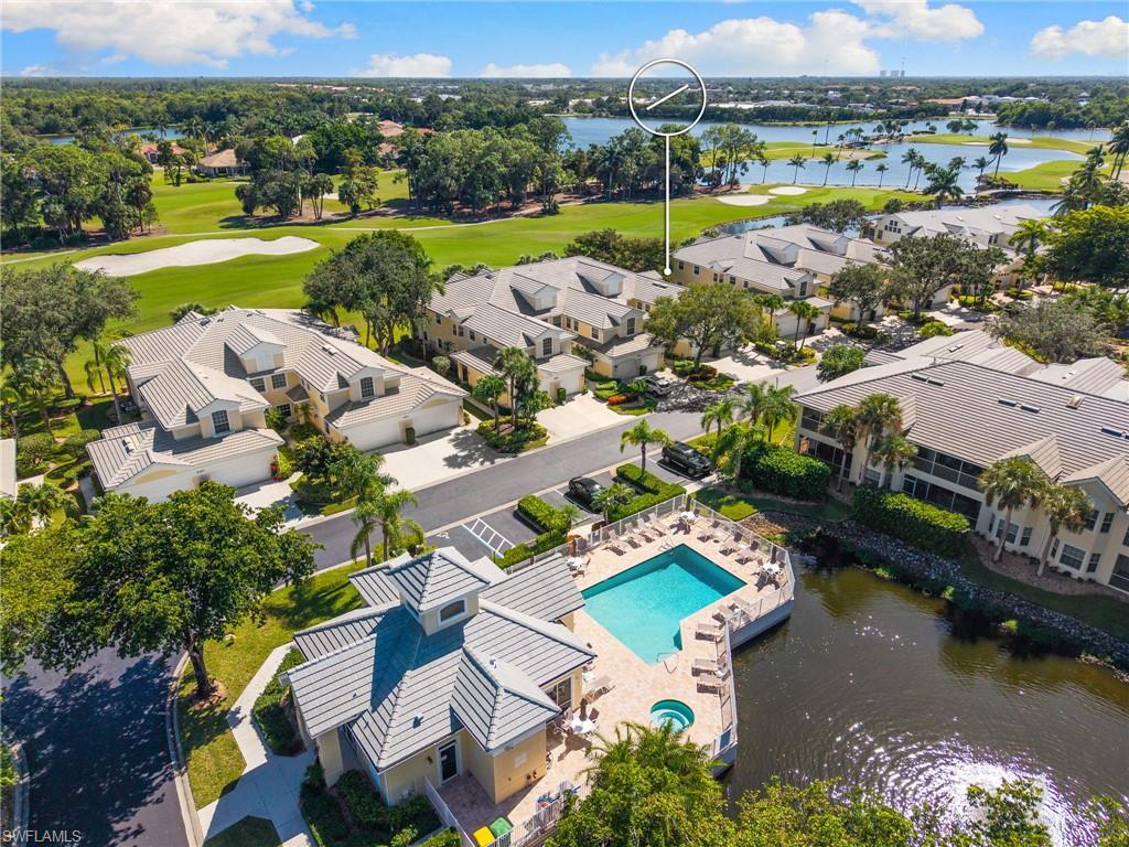 8500 Mystic Greens Way, Unit 506 Naples, FL 34113 - Photo 2 of 48 an aerial view of a house with a lake view