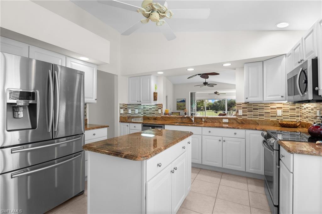 8500 Mystic Greens Way, Unit 506 Naples, FL 34113 - Photo 22 of 48 a kitchen with granite countertop a sink stainless steel appliances and cabinets