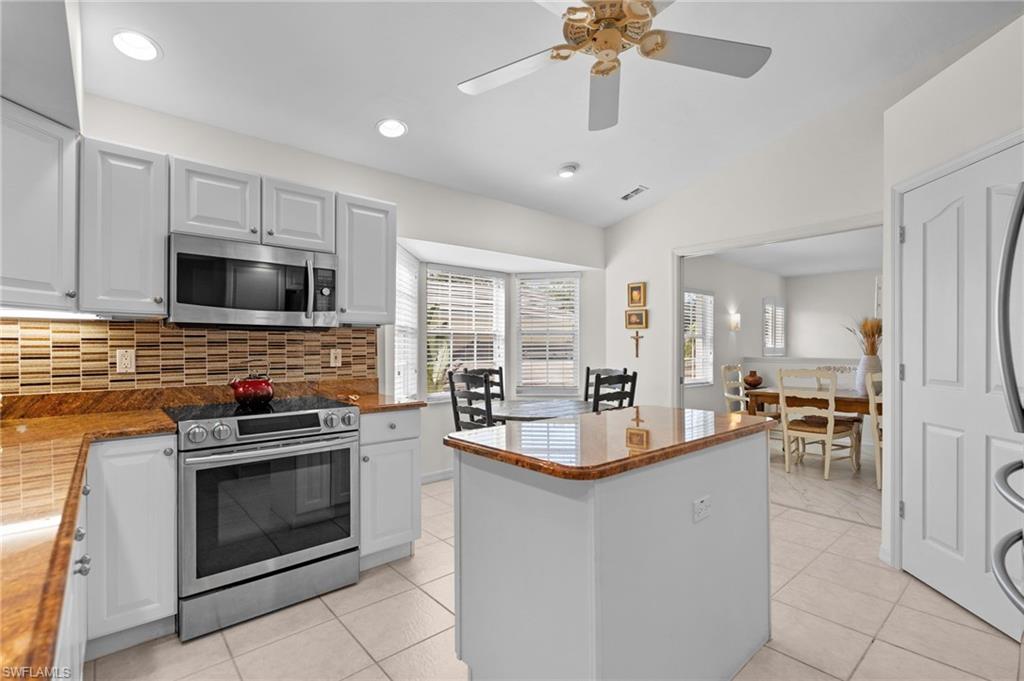 8500 Mystic Greens Way, Unit 506 Naples, FL 34113 - Photo 24 of 48 a kitchen with granite countertop a stove oven and sink
