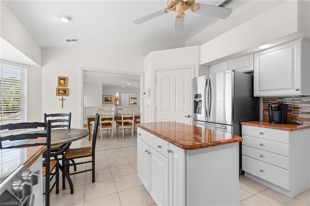 8500 Mystic Greens Way, Unit 506 Naples, FL 34113 - Photo 25 of 48 a kitchen with granite countertop cabinets and refrigerator