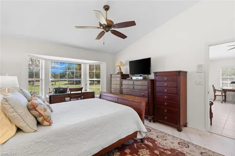 a bathroom with a granite countertop sink a toilet a mirror and shower