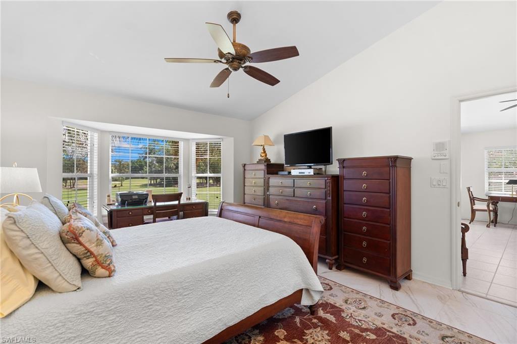 8500 Mystic Greens Way, Unit 506 Naples, FL 34113 - Photo 28 of 48 a large bedroom with a bed and flat screen tv