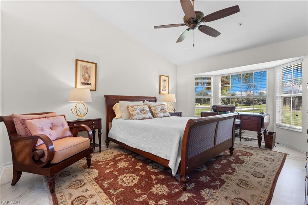 8500 Mystic Greens Way, Unit 506 Naples, FL 34113 - Photo 29 of 48 a bedroom with a bed and a couch