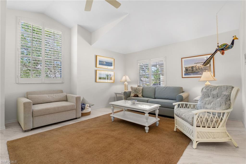 8500 Mystic Greens Way, Unit 506 Naples, FL 34113 - Photo 33 of 48 a living room with furniture and a large window