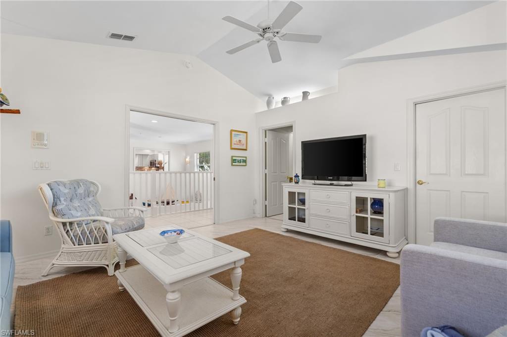 8500 Mystic Greens Way, Unit 506 Naples, FL 34113 - Photo 34 of 48 a living room with furniture and a flat screen tv