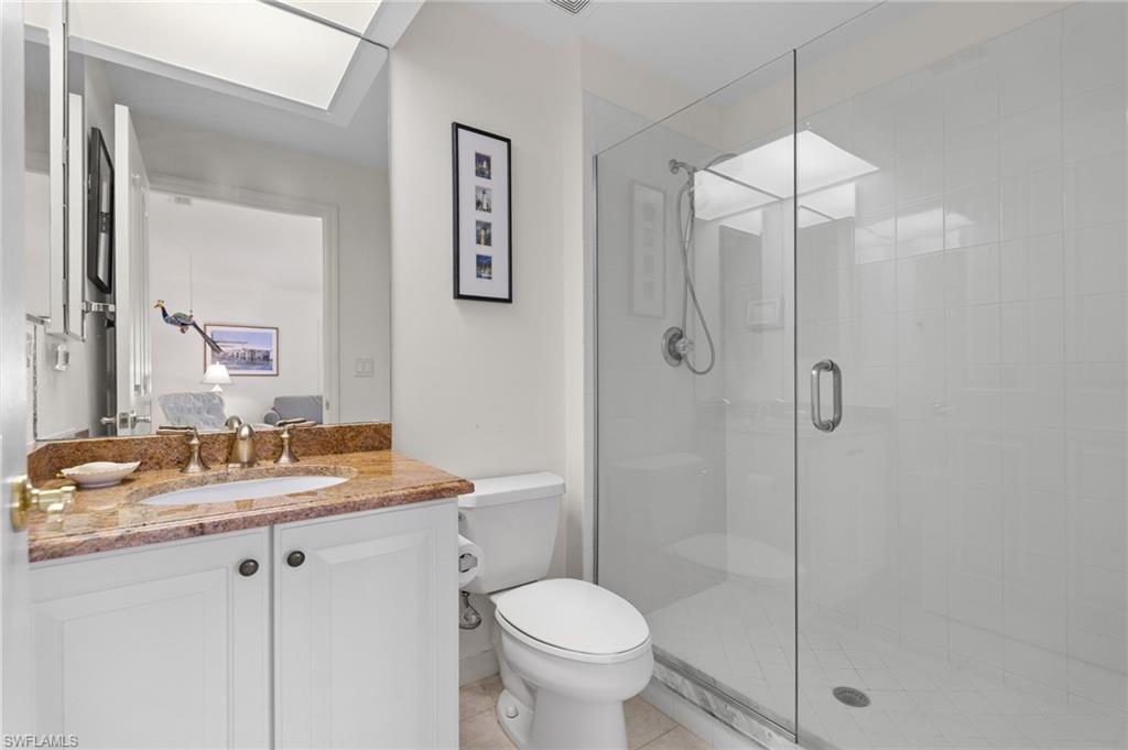 8500 Mystic Greens Way, Unit 506 Naples, FL 34113 - Photo 35 of 48 a bathroom with a granite countertop sink toilet and shower