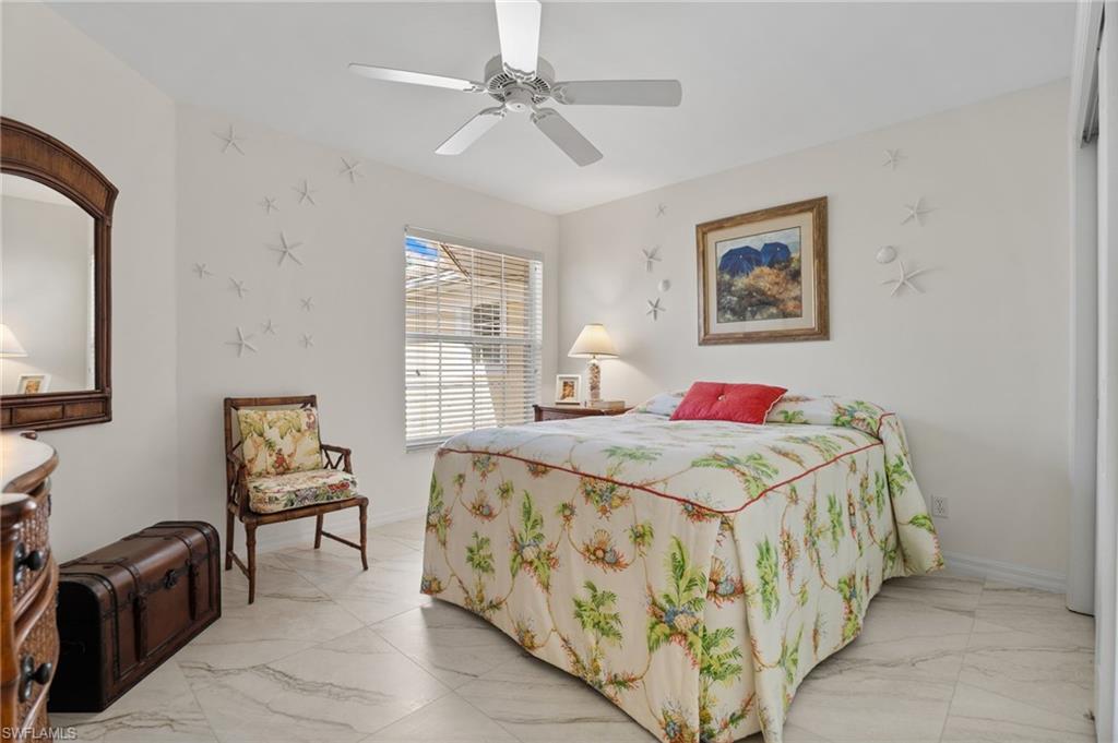 8500 Mystic Greens Way, Unit 506 Naples, FL 34113 - Photo 36 of 48 a bedroom with a bed and a flat screen tv