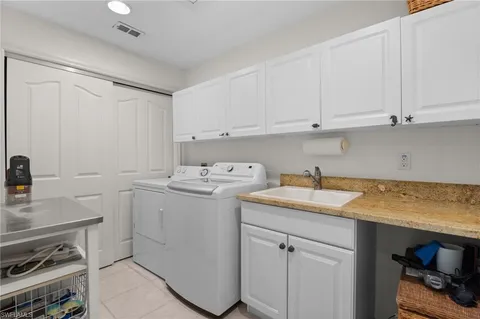 aerial view of a city with lots of residential buildings ocean and mountain view in back