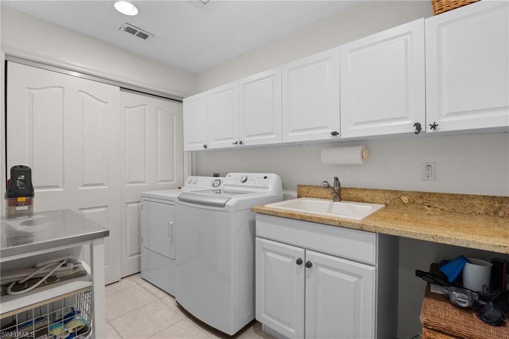 8500 Mystic Greens Way, Unit 506 Naples, FL 34113 - Photo 38 of 48 a utility room with sink dryer and washer