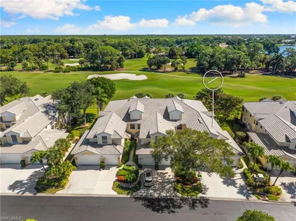 an aerial view of residential houses with outdoor space and river