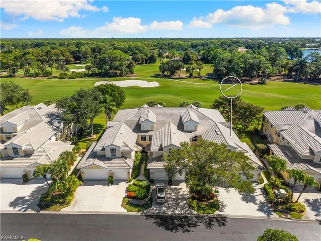 an aerial view of residential houses with outdoor space and river