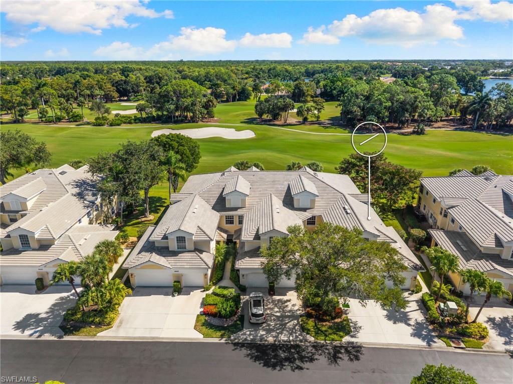 8500 Mystic Greens Way, Unit 506 Naples, FL 34113 - Photo 39 of 48 an aerial view of a house with a garden and lake view