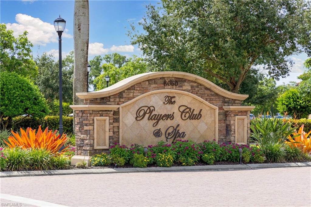 8500 Mystic Greens Way, Unit 506 Naples, FL 34113 - Photo 44 of 48 a wooden sign on the side of a road