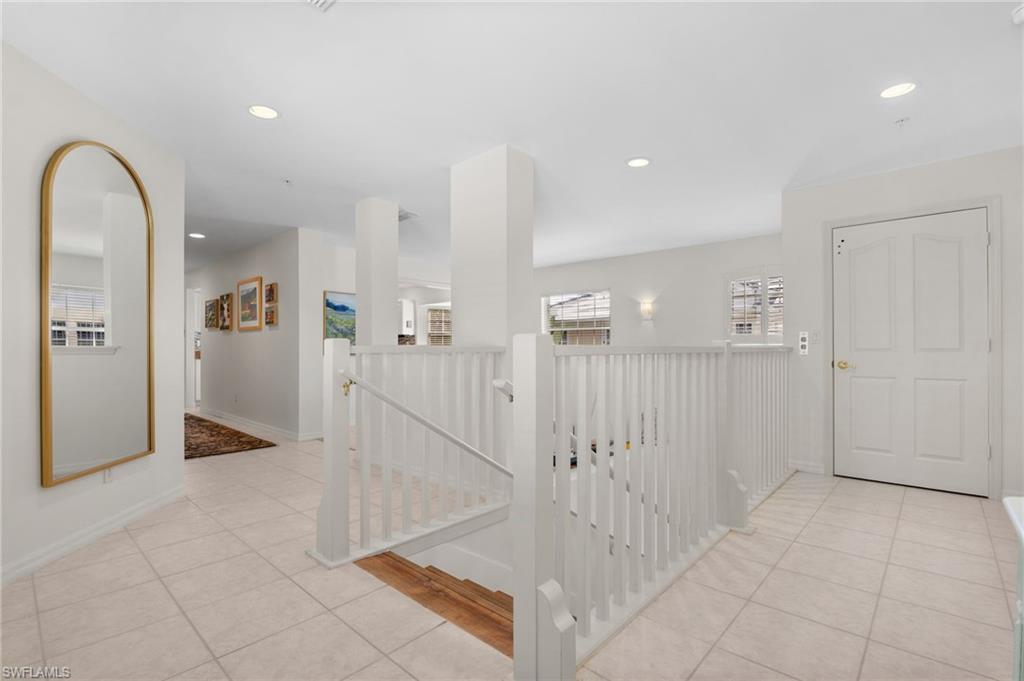 8500 Mystic Greens Way, Unit 506 Naples, FL 34113 - Photo 9 of 48 a view of entryway with white walls and chandelier