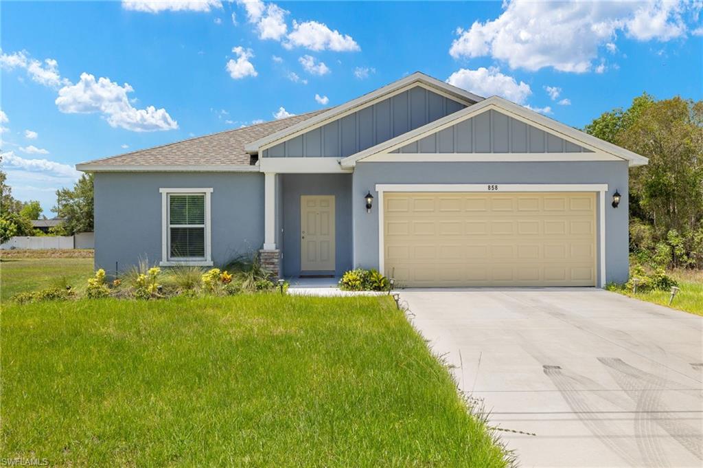 858 Rue Labeau Circle Fort Myers, FL 33913 - Photo 19 of 19 View of front facade with a garage and a front lawn