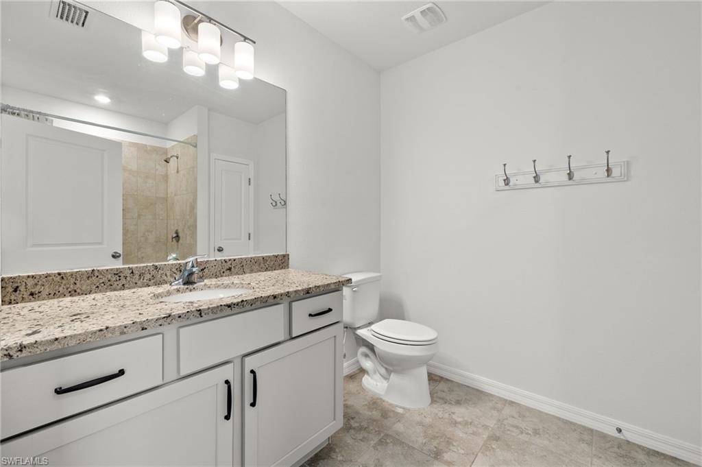 858 Rue Labeau Circle Fort Myers, FL 33913 - Photo 7 of 19 Bathroom with tile flooring, large vanity, and toilet