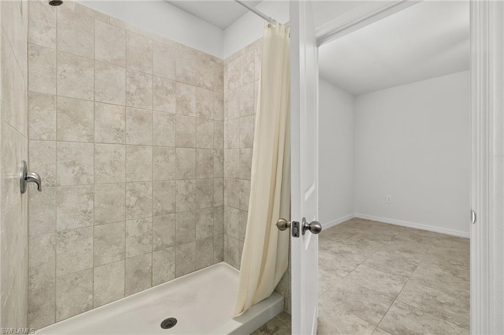 858 Rue Labeau Circle Fort Myers, FL 33913 - Photo 8 of 19 Bathroom with a shower with curtain and tile flooring