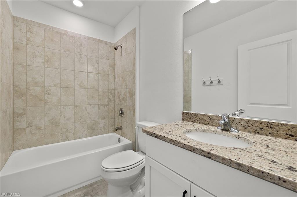 858 Rue Labeau Circle Fort Myers, FL 33913 - Photo 10 of 19 Full bathroom with toilet, tiled shower / bath combo, and oversized vanity