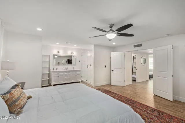 a bathroom with a shower sink and mirror