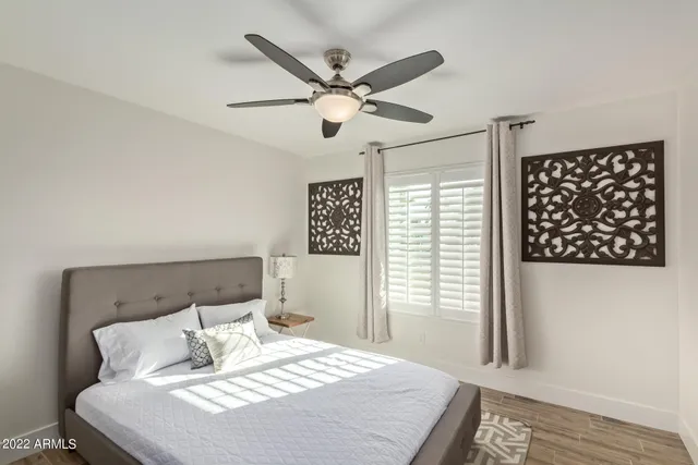 a bedroom with a bed and a chandelier