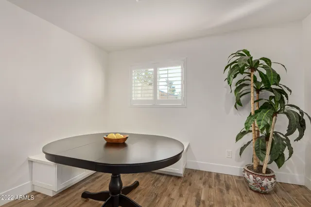 a view of a workspace with a table and a potted plant