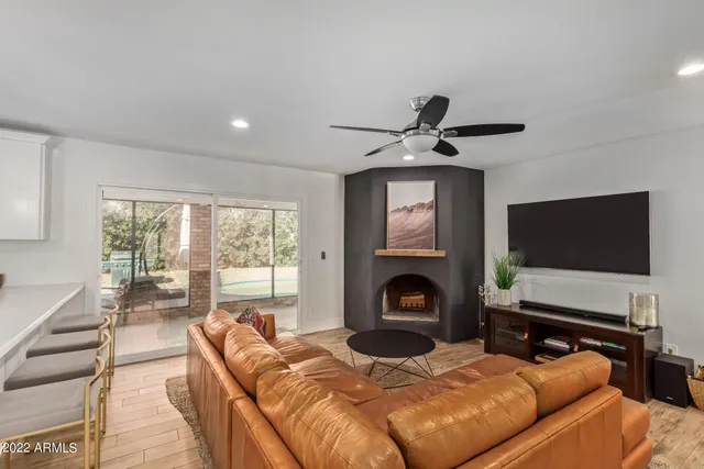 a living room with furniture flat screen tv and a fireplace