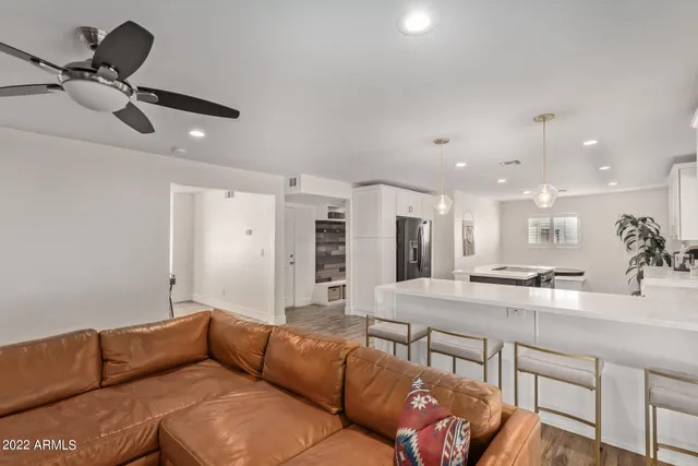 a living room with furniture and kitchen view