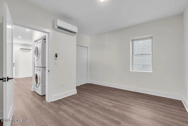 an empty room with wooden floor and a window