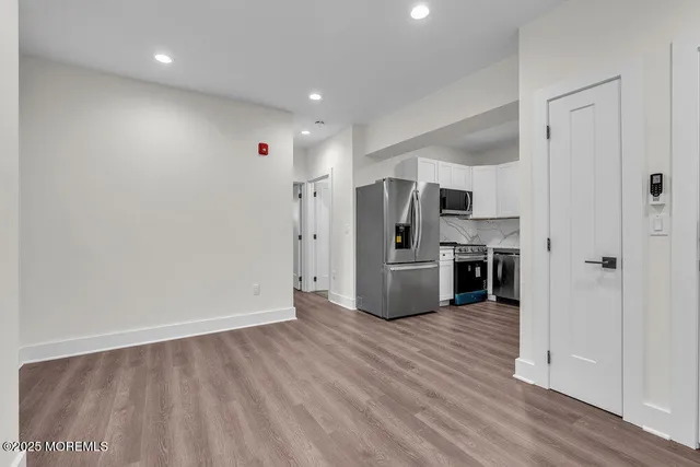 a view of a kitchen with a sink and a refrigerator
