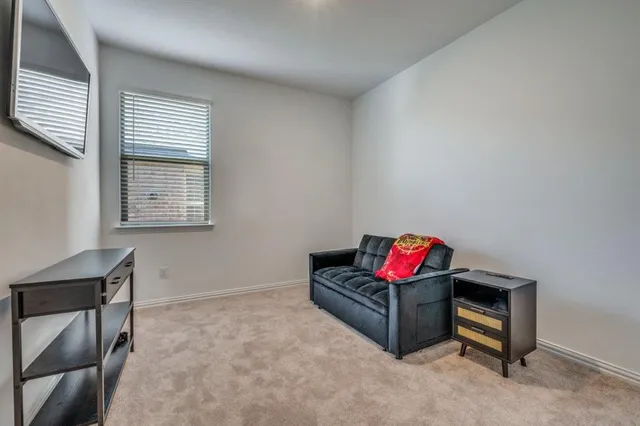 a bed sitting in a bedroom next to a window