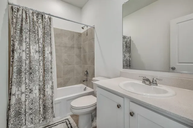 a bedroom with a bed and a television