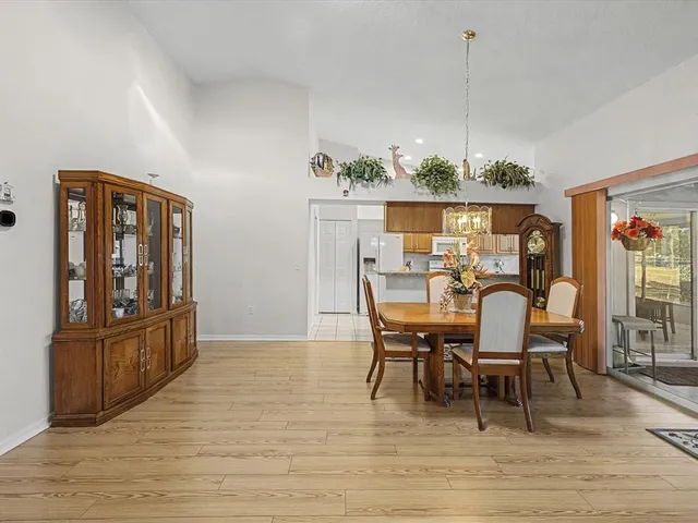 a kitchen with stainless steel appliances granite countertop a sink and a refrigerator