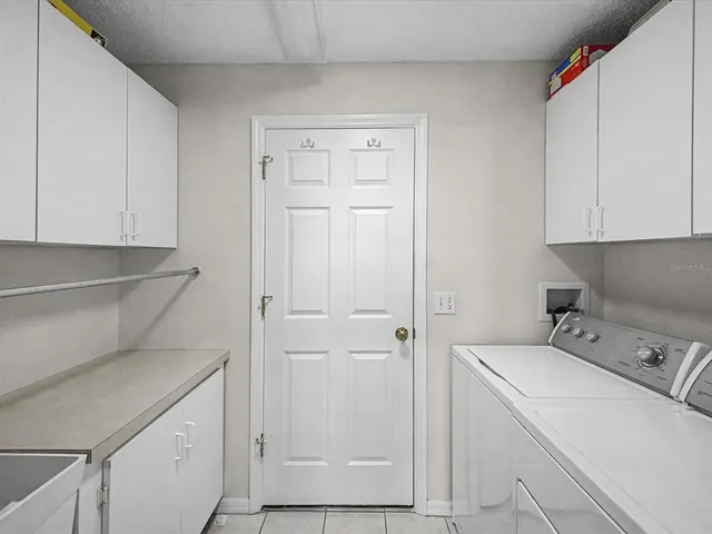 a view of house with yard and furniture