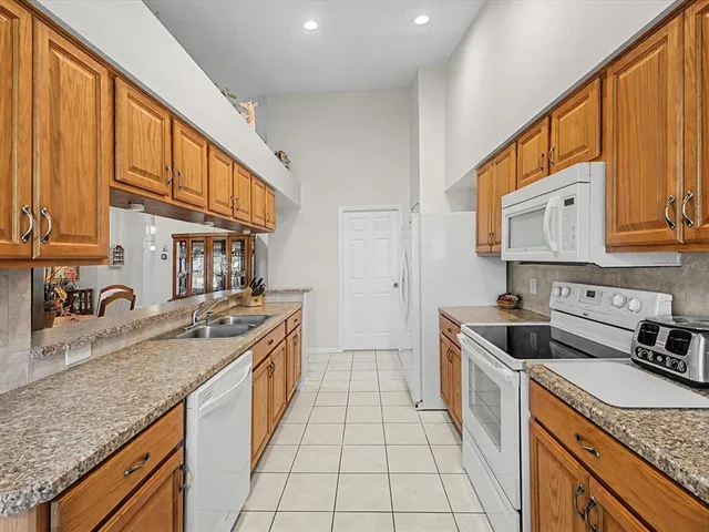 a kitchen with stainless steel appliances granite countertop a sink stove and cabinets