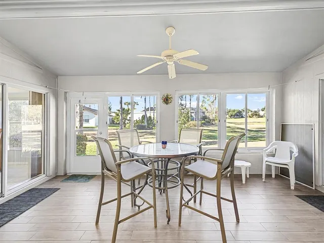 a view of a dining room with furniture wooden floor and chandelier