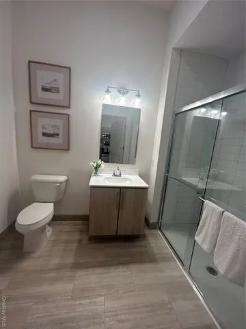 a bathroom with a sink toilet and shower