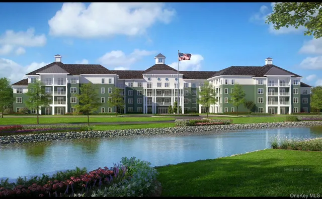 a view of a house with a yard and a pond