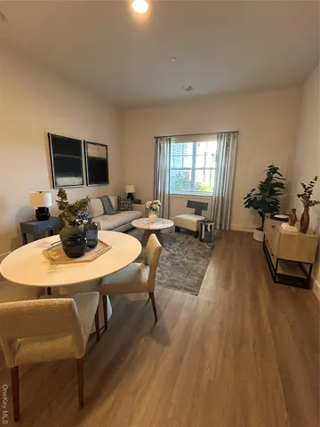 a living room with furniture wooden floor and a flat screen tv